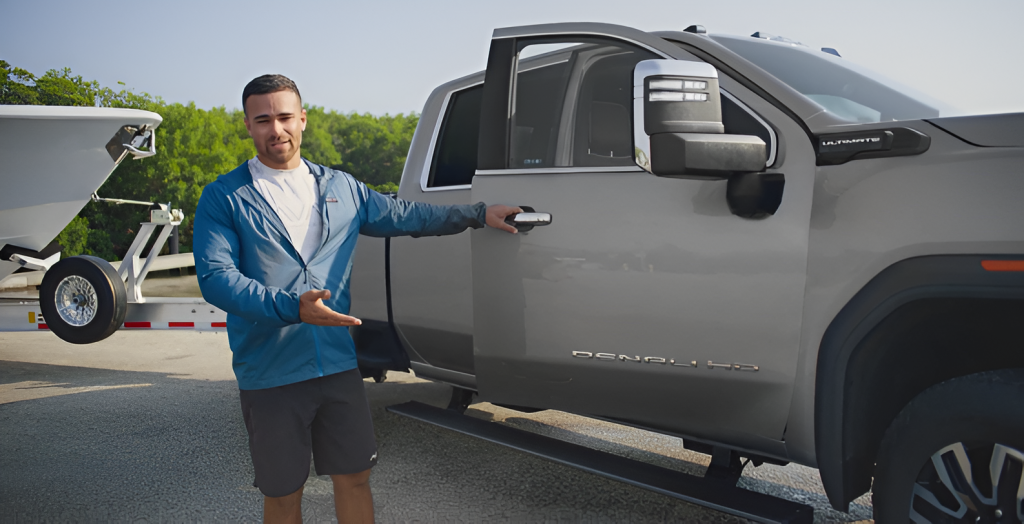 Man opening the passenger door of a truck towing a boat