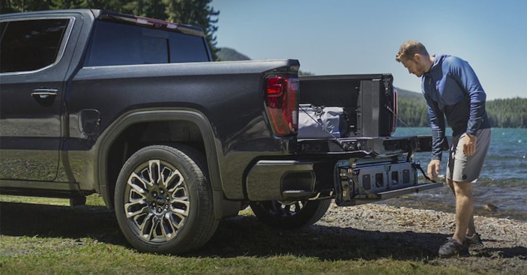 Man opening the tailgate of a truck