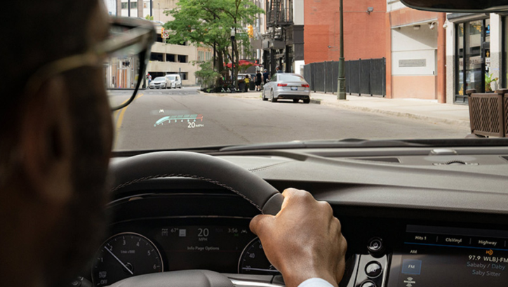 Person driving a vehicle; view out of the windshield of a street