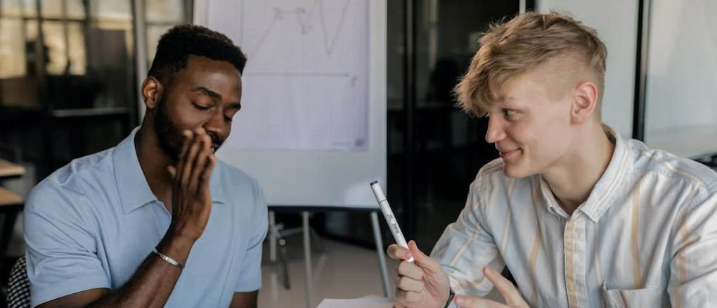 Two guys talking at a dealership