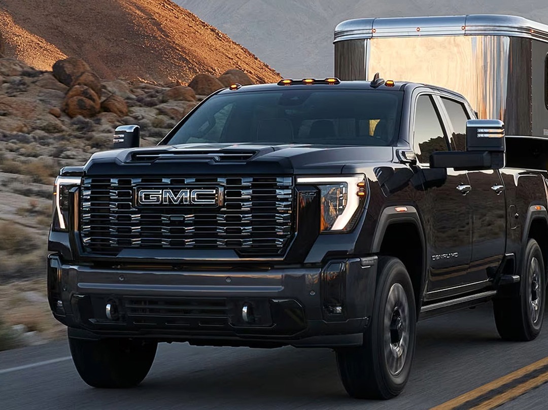 GMC Sierra 2500 HD towing a horse trailer through the mountains